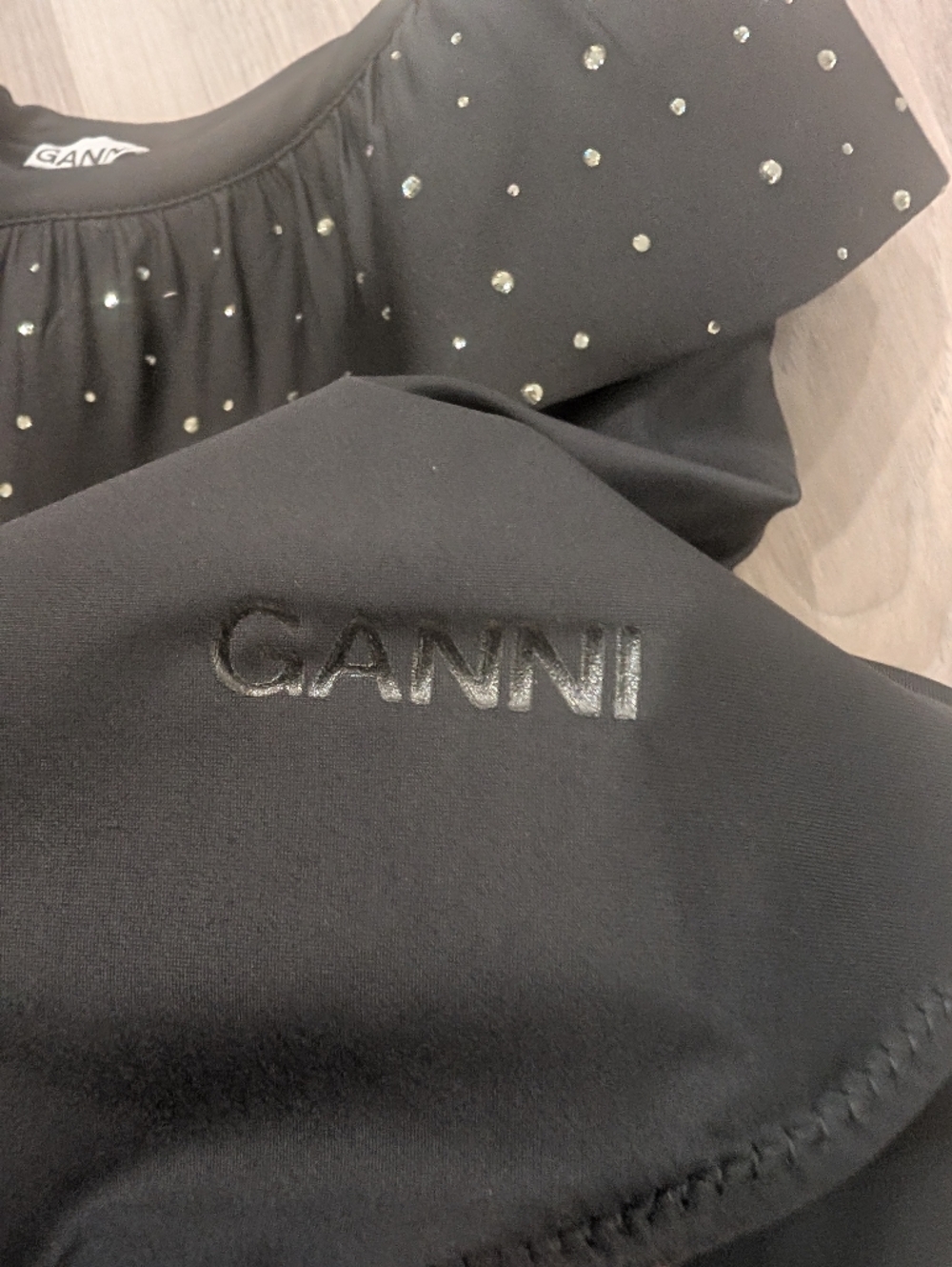 GANNI | Ruffled Rhinestone One-Shoulder Bodysuit In Black - Picture 7 of 11